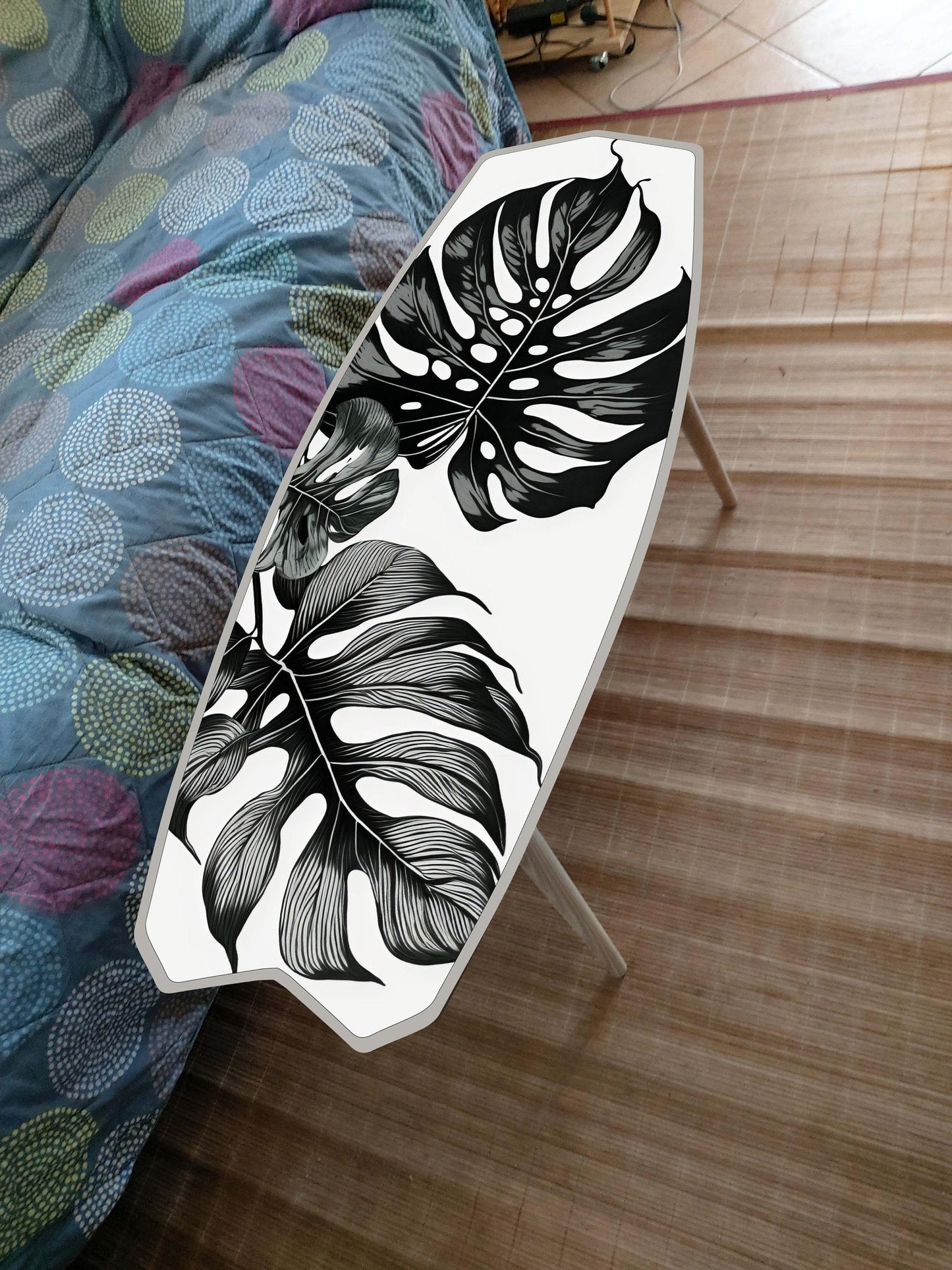 Surfboard shaped coffee table with monstery leaves in black and white design