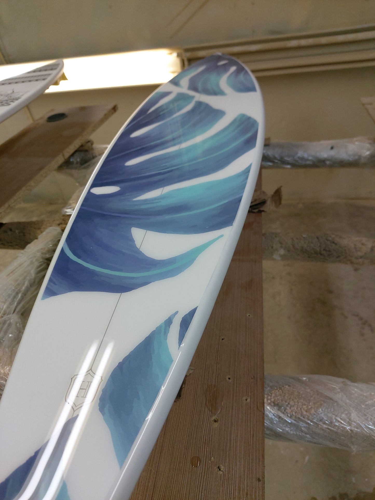 Handmade White Surfboard Wall Hanging with Blue-Emerald Monstera Leaves Pattern
