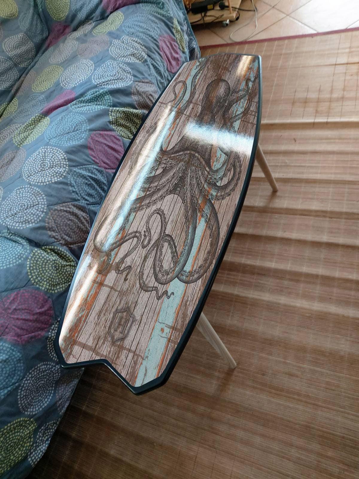 Surfboard coffee table with black octopus print for nautical decor