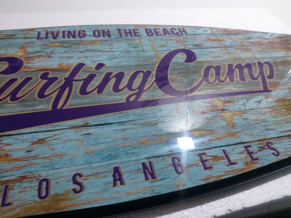 Surfboard shaped coffee table with monstery leaves in black and white design