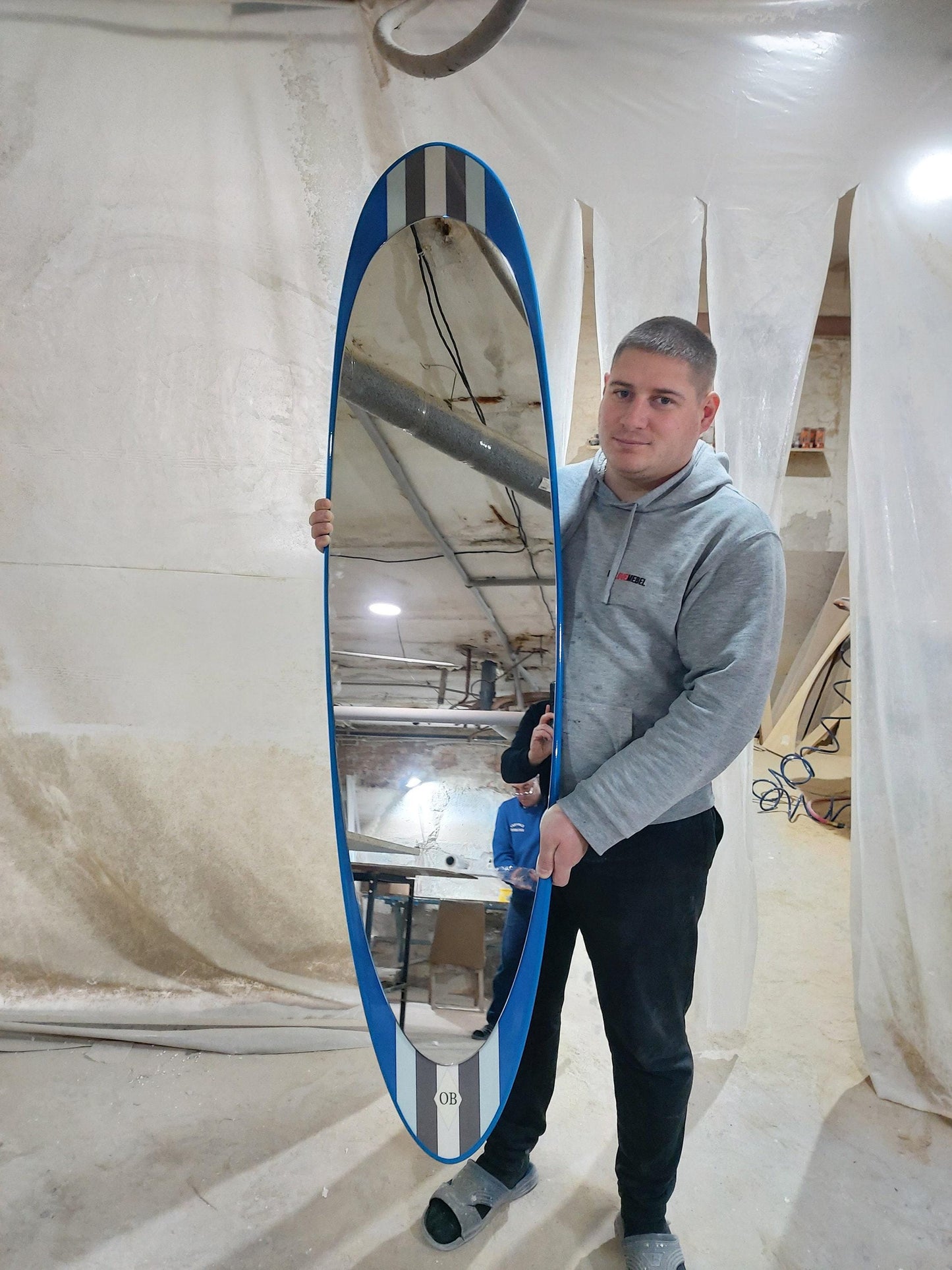 Wall mirror in surfboard shaped frame