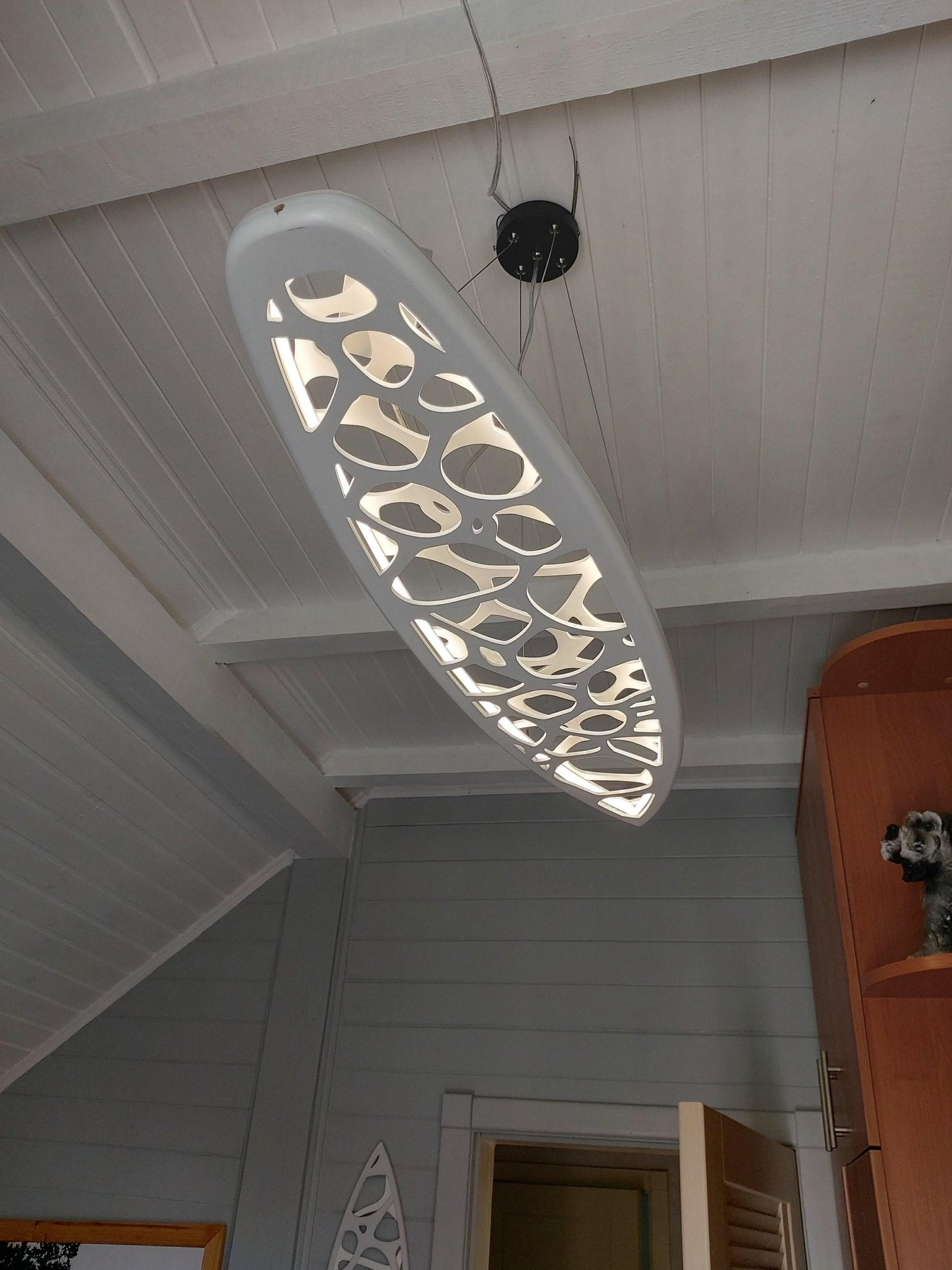 Surfboard shaped wooden decorative chandelier with carved sea ripple effect