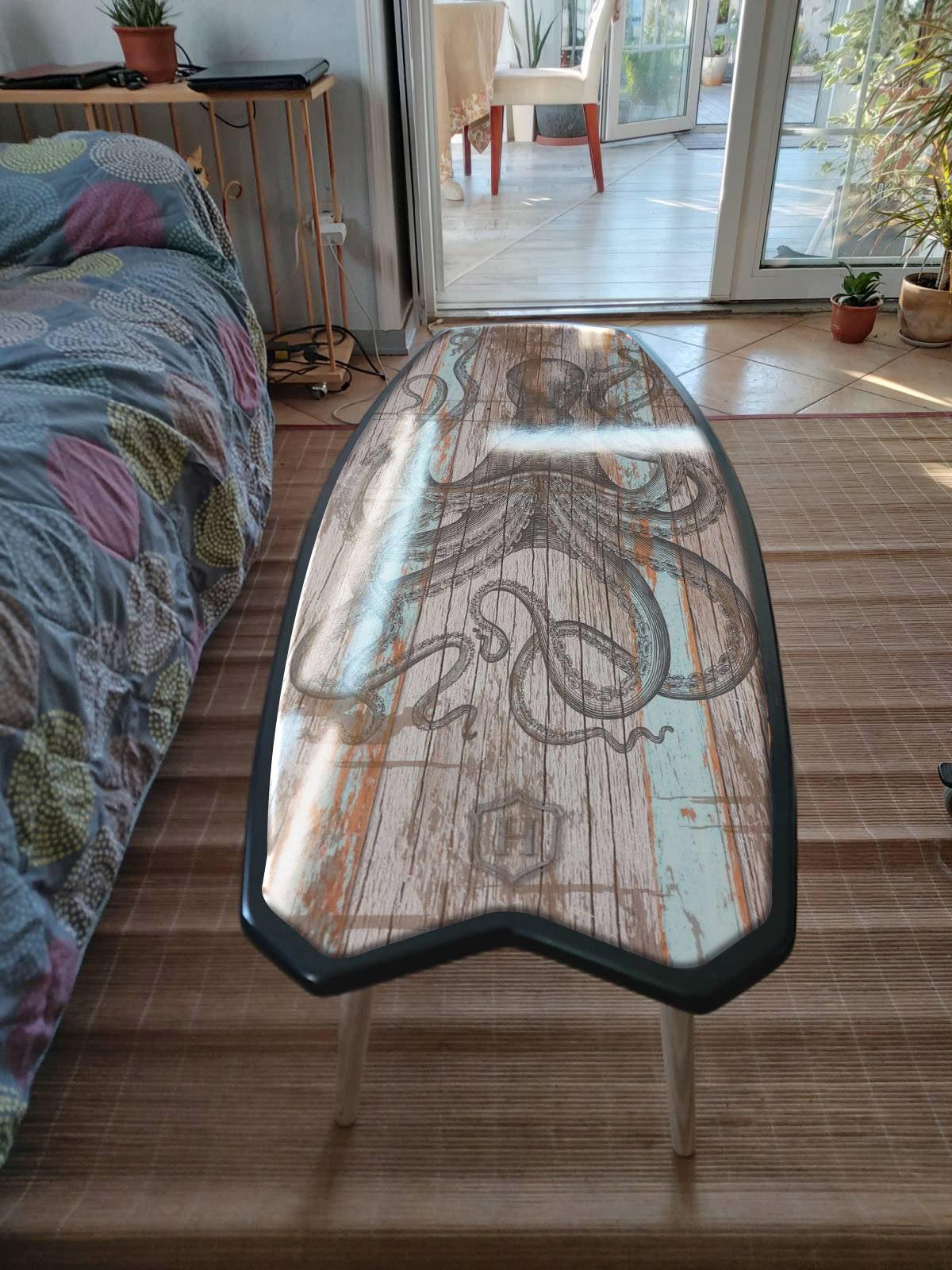 Surfboard coffee table with black octopus print for nautical decor