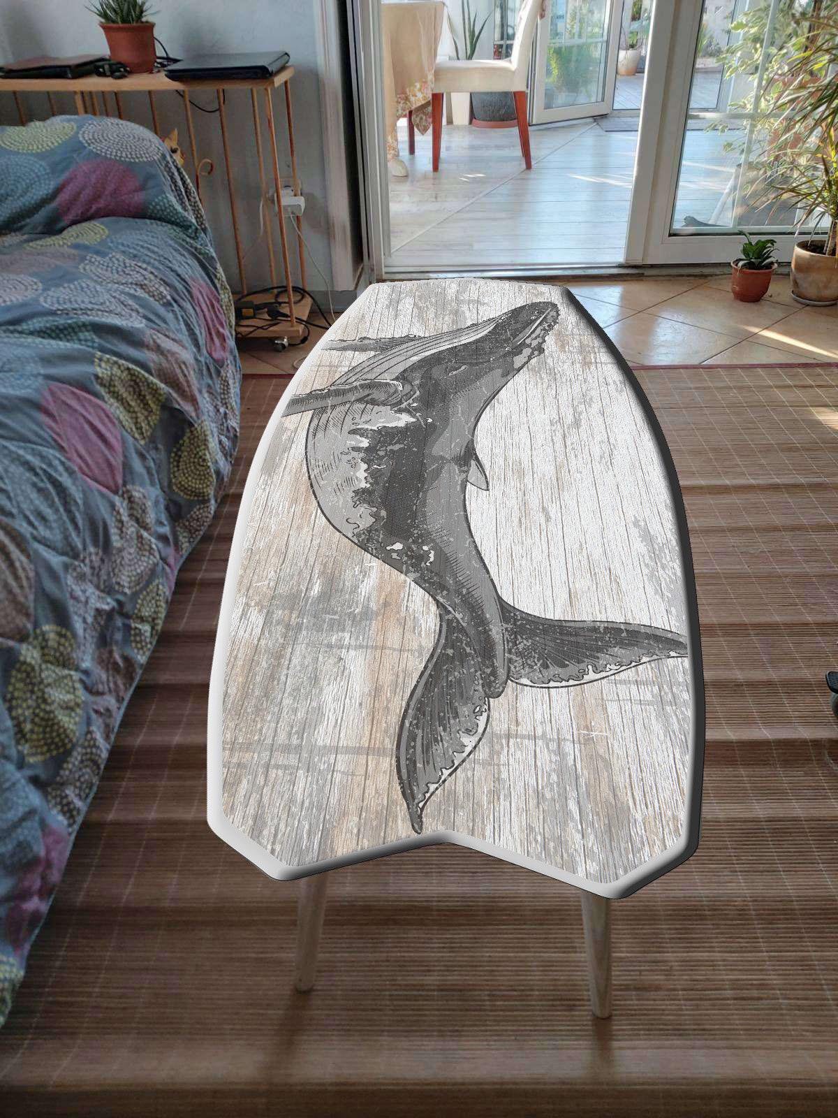 Surfboard shaped coffee table with monstery leaves in black and white design
