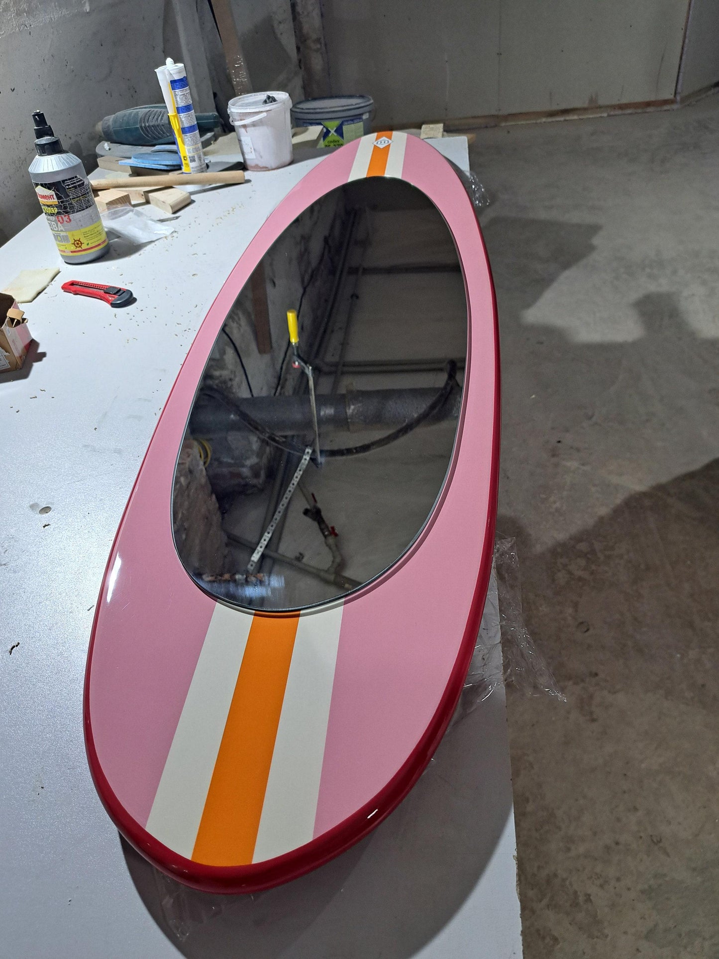 Wall mirror in surfboard shaped frame