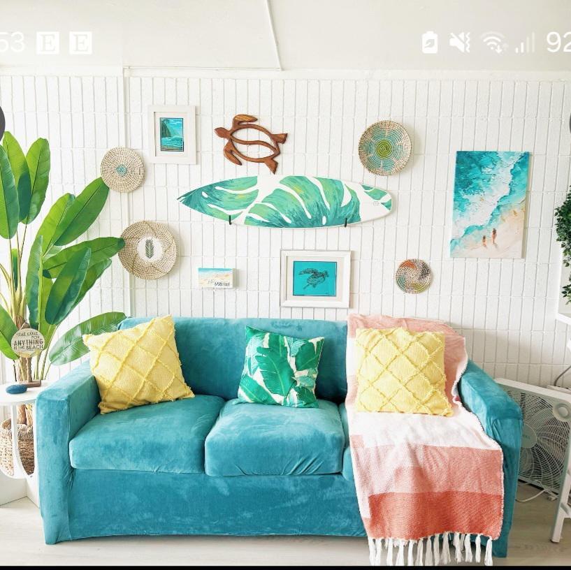 Surfboard with green monstera leaves