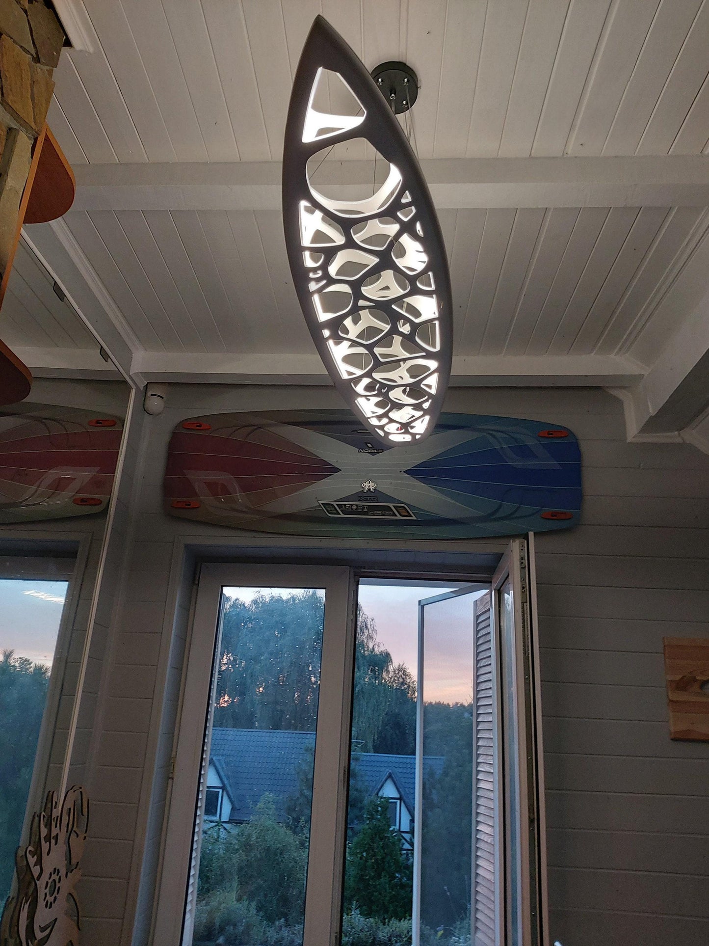 Surfboard shaped wooden decorative chandelier with carved sea ripple effect